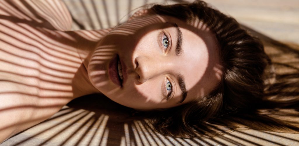 Portrait,Of,Beautiful,Woman,With,Shadows,Of,Palm,Leaf,On